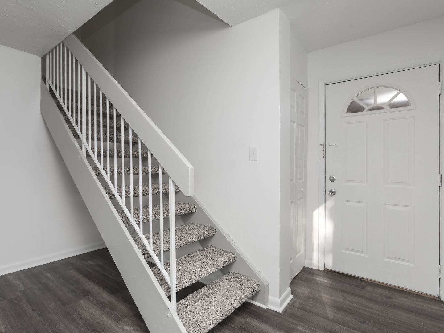 701 Spring Court, Unit 5 University Park, IL 60484 - Photo 9 of 17 a view of a hallway with wooden floor and staircase