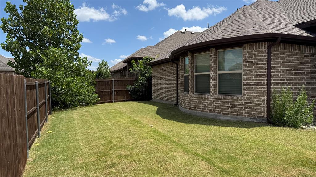 14712 Spitfire Trail Fort Worth, TX 76262 - Photo 5 of 25 Spacious backyard featuring a full wood privacy fence and mature trees