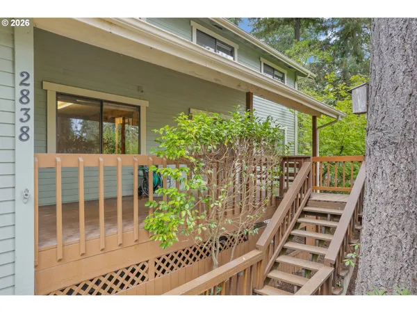 a view of a balcony with wooden floor and fence