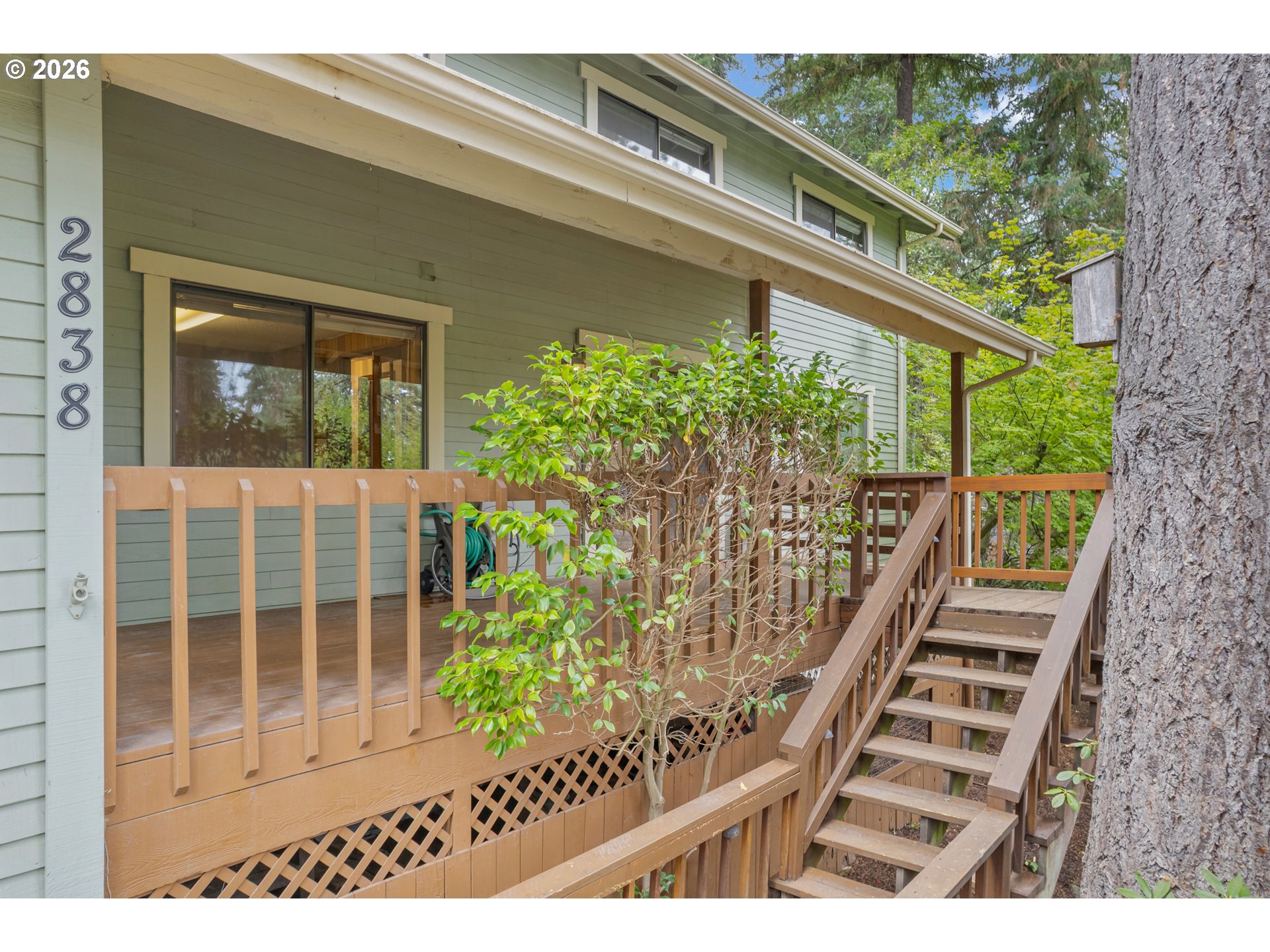 a view of a balcony with wooden floor and fence
