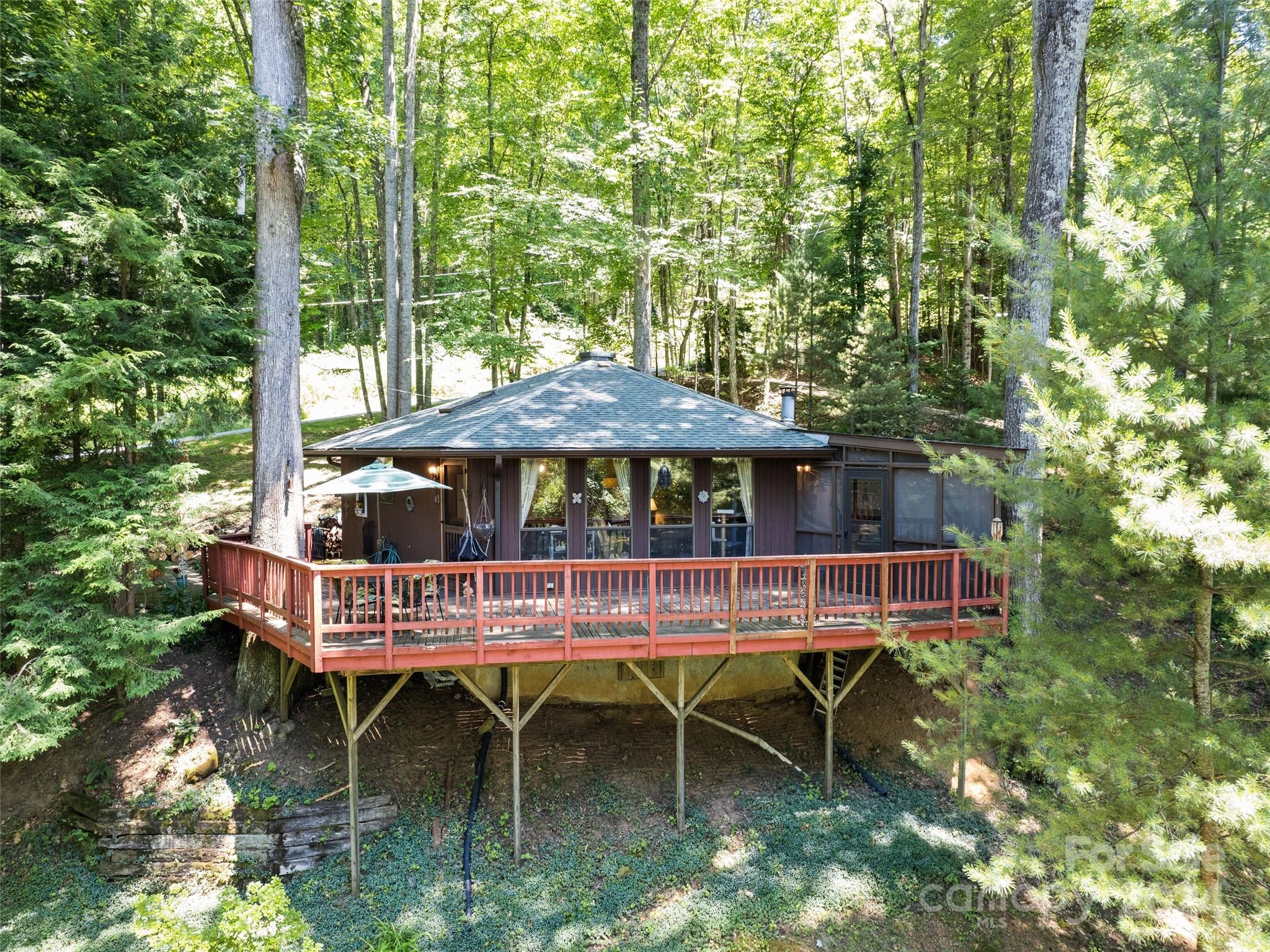 1004 Old Country Road Waynesville, NC 28786 - Photo 1 of 30 a view of table and chairs under an umbrella