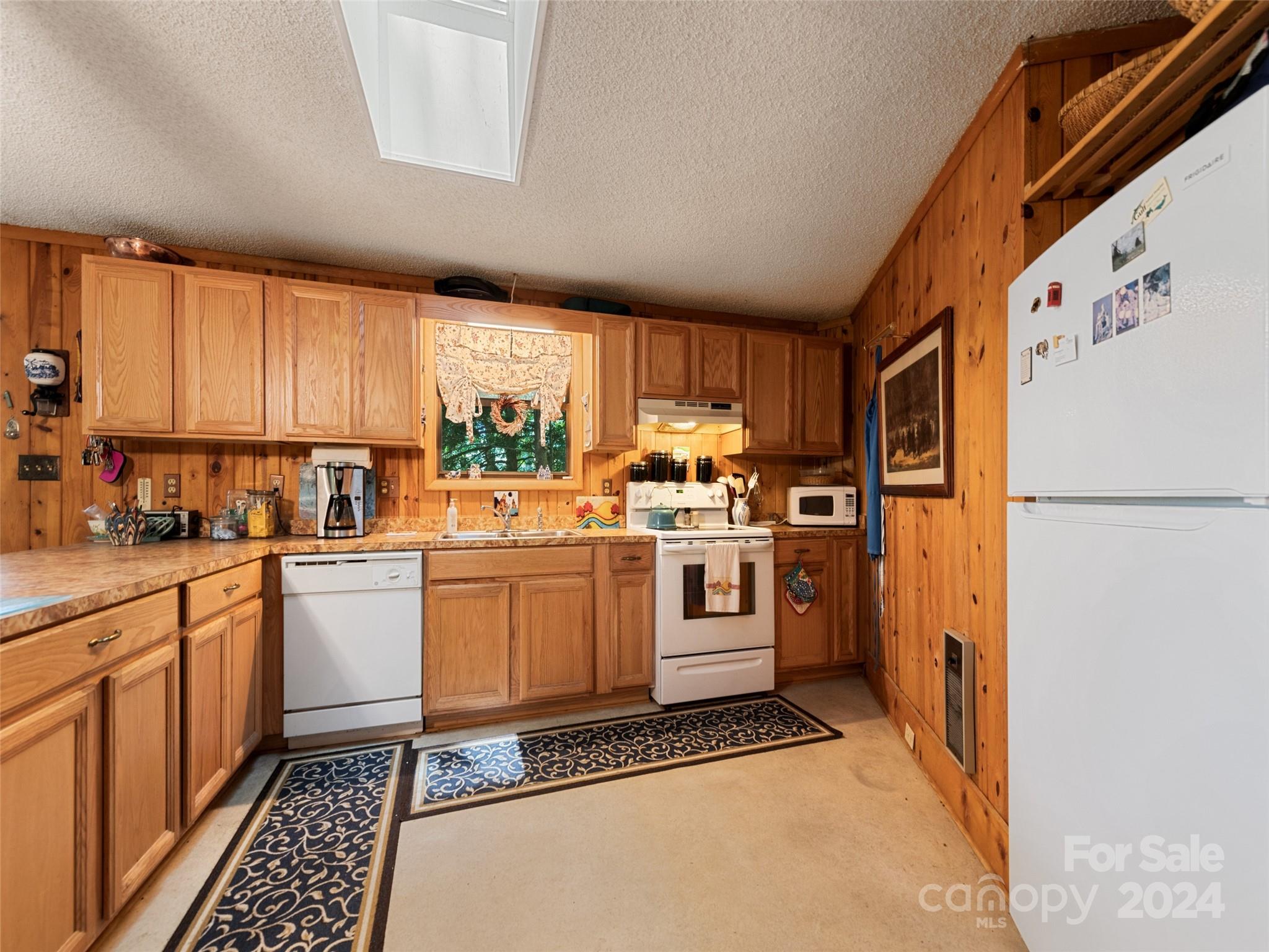 1004 Old Country Road Waynesville, NC 28786 - Photo 20 of 30 a kitchen with a refrigerator sink and cabinets