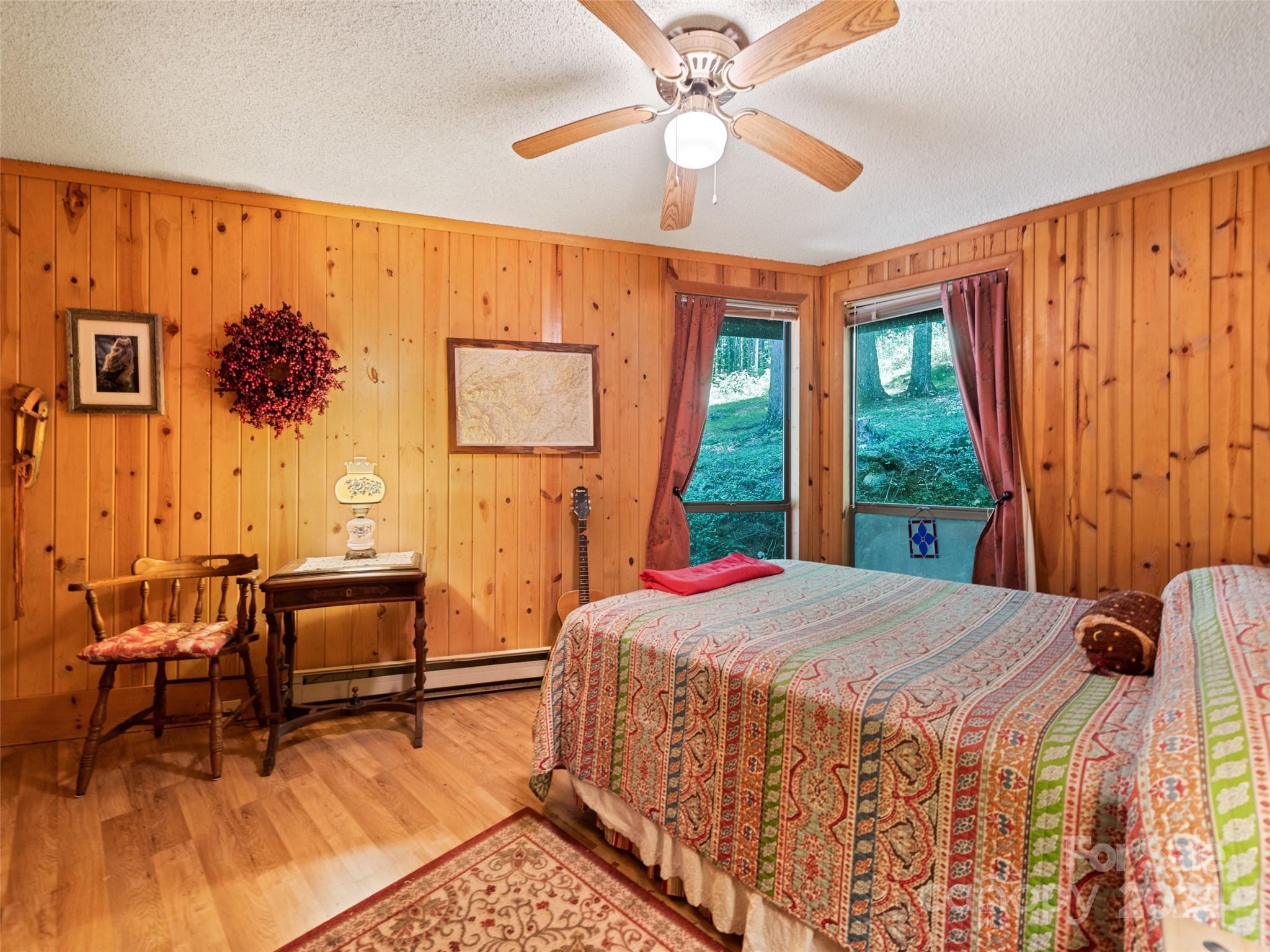 1004 Old Country Road Waynesville, NC 28786 - Photo 25 of 30 a bedroom with a bed and wooden floor