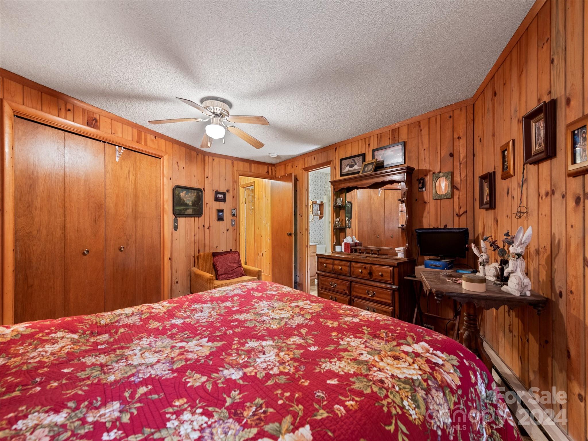 1004 Old Country Road Waynesville, NC 28786 - Photo 28 of 30 a bedroom with a bed and a flat tv screen