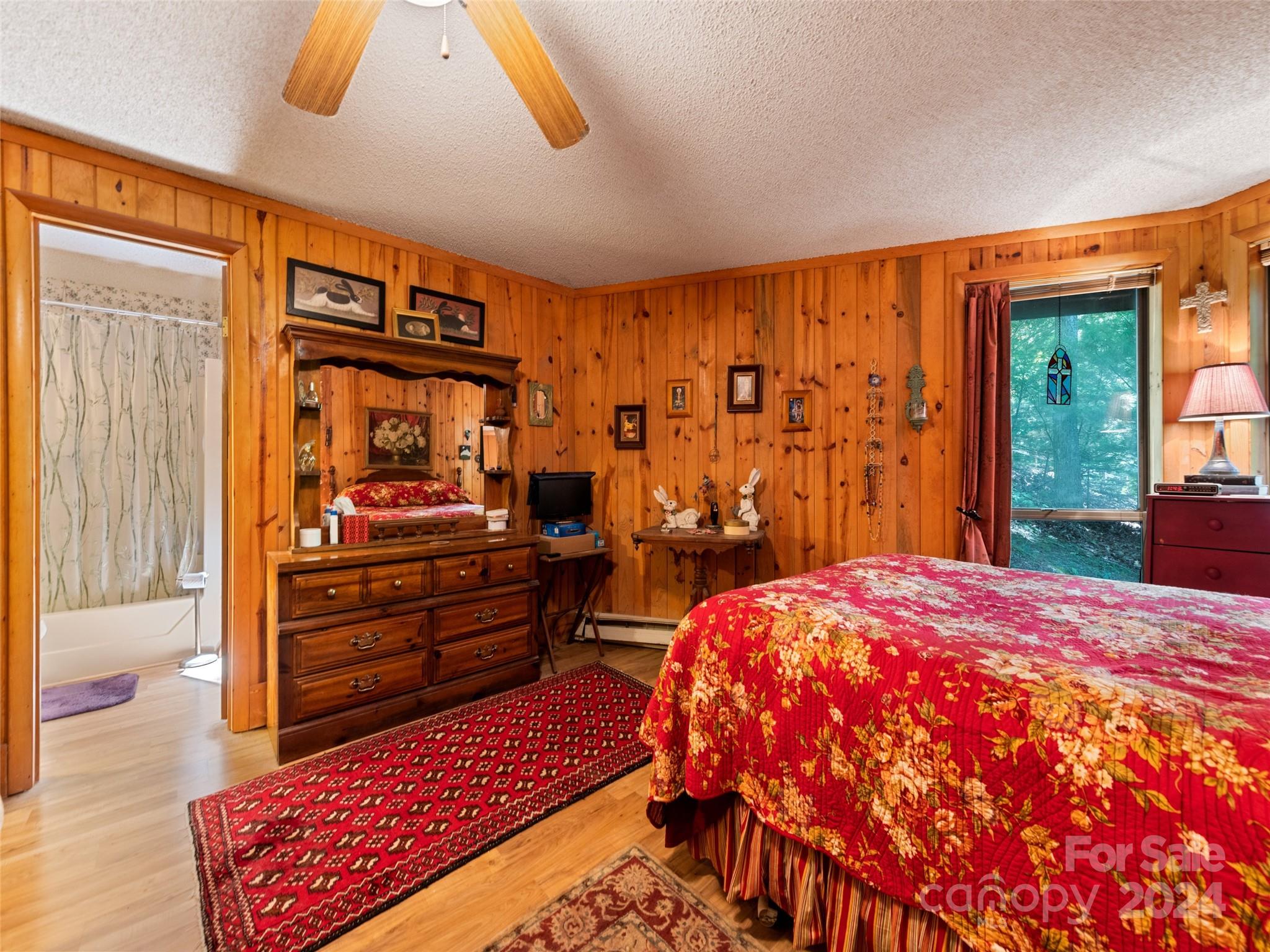1004 Old Country Road Waynesville, NC 28786 - Photo 29 of 30 a bedroom with a bed and wooden floor