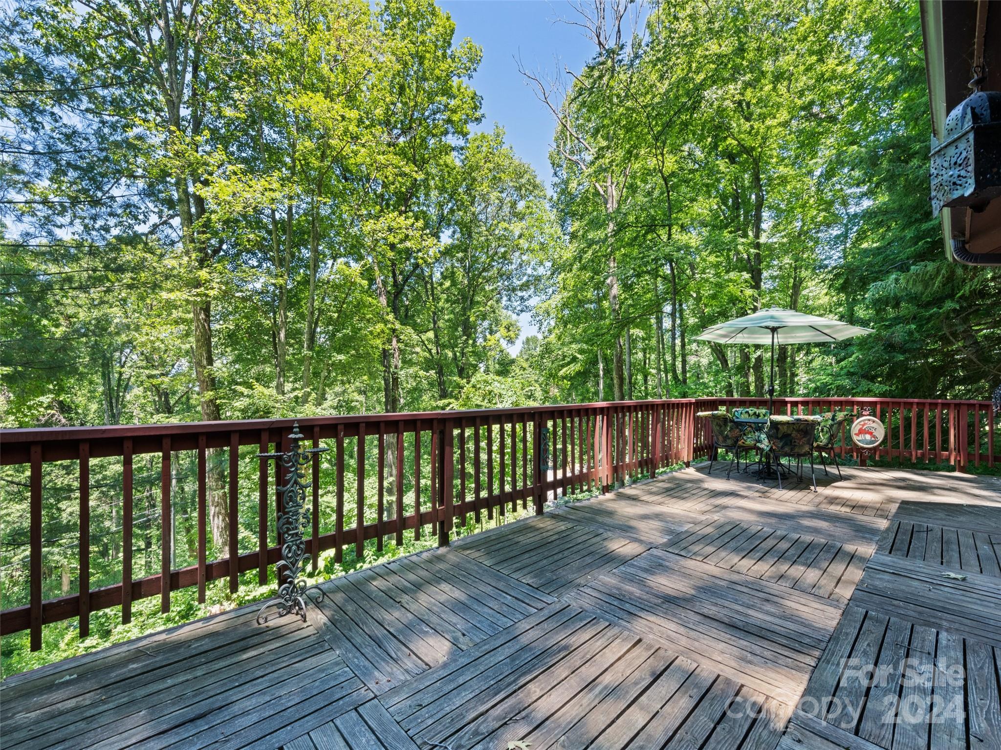 1004 Old Country Road Waynesville, NC 28786 - Photo 10 of 30 a view of balcony with wooden floor and outdoor seating
