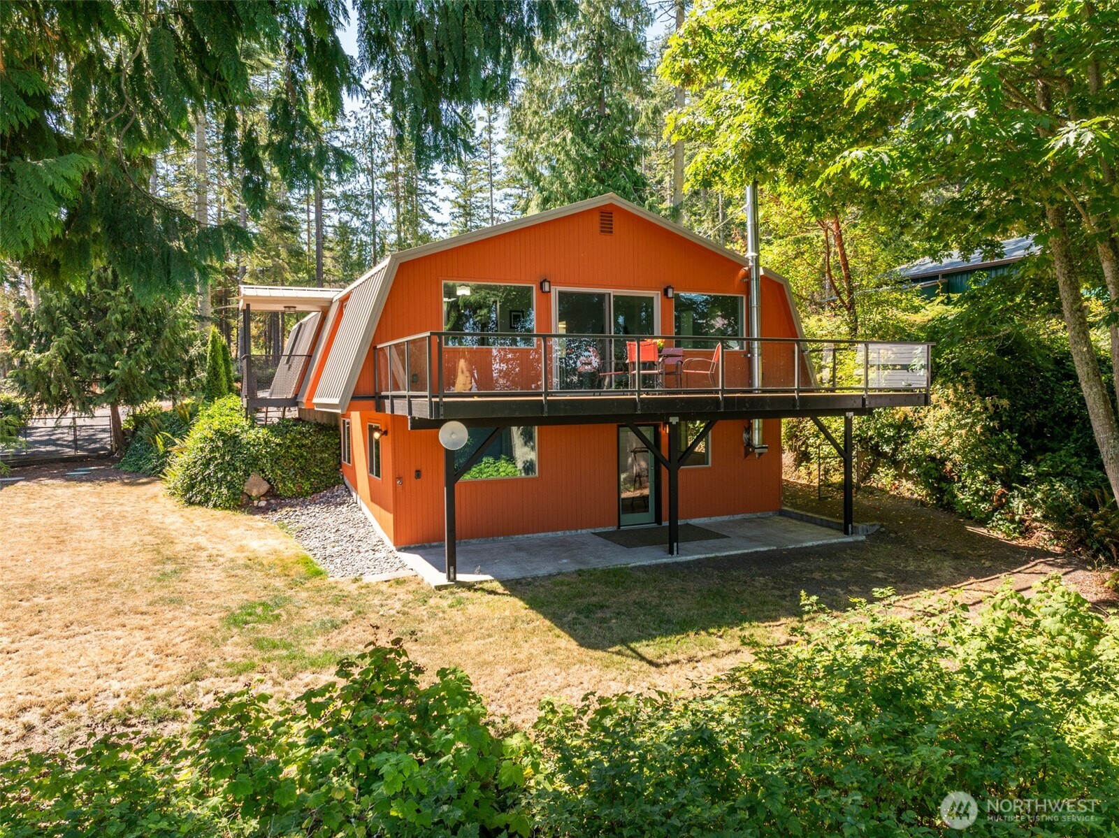 681 Bachelor Road Sequim, WA 98382 - Photo 38 of 39 a backyard of a house with yard and outdoor seating