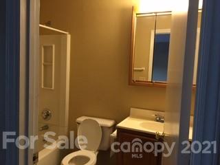 11086 Harrowfield Road Charlotte, NC 28226 - Photo 4 of 6 a bathroom with a sink mirror and toilet