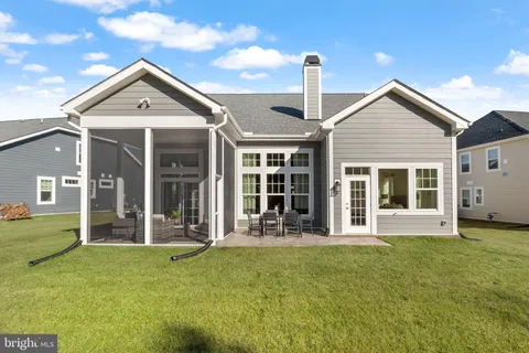 a front view of a house with a yard and seating space