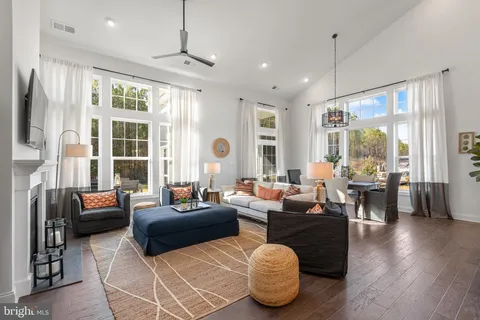 a living room with fireplace furniture and a large window