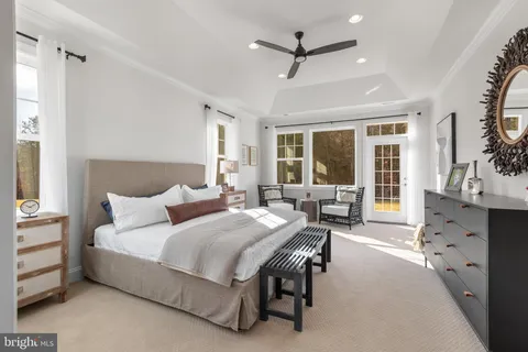 a bedroom with furniture and a large window