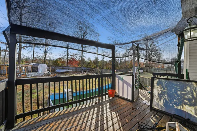 a view of a balcony with furniture and wooden floor