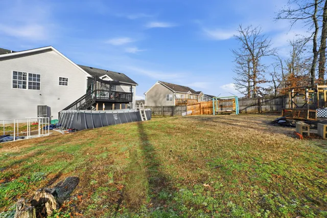 a view of a large house with a big yard and large trees