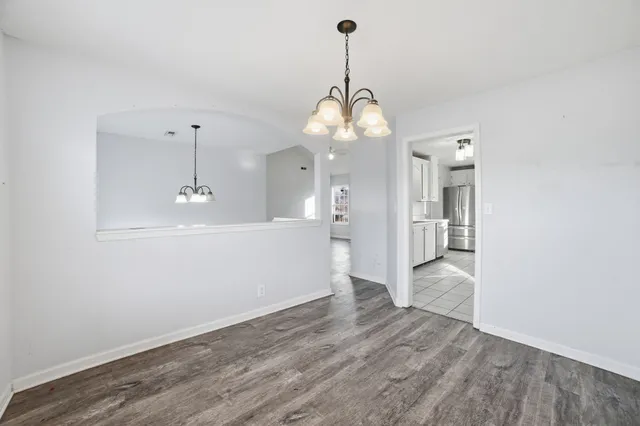 a view of a kitchen with a sink and wooden floor