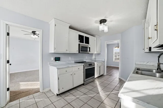 a large kitchen with cabinets and stainless steel appliances
