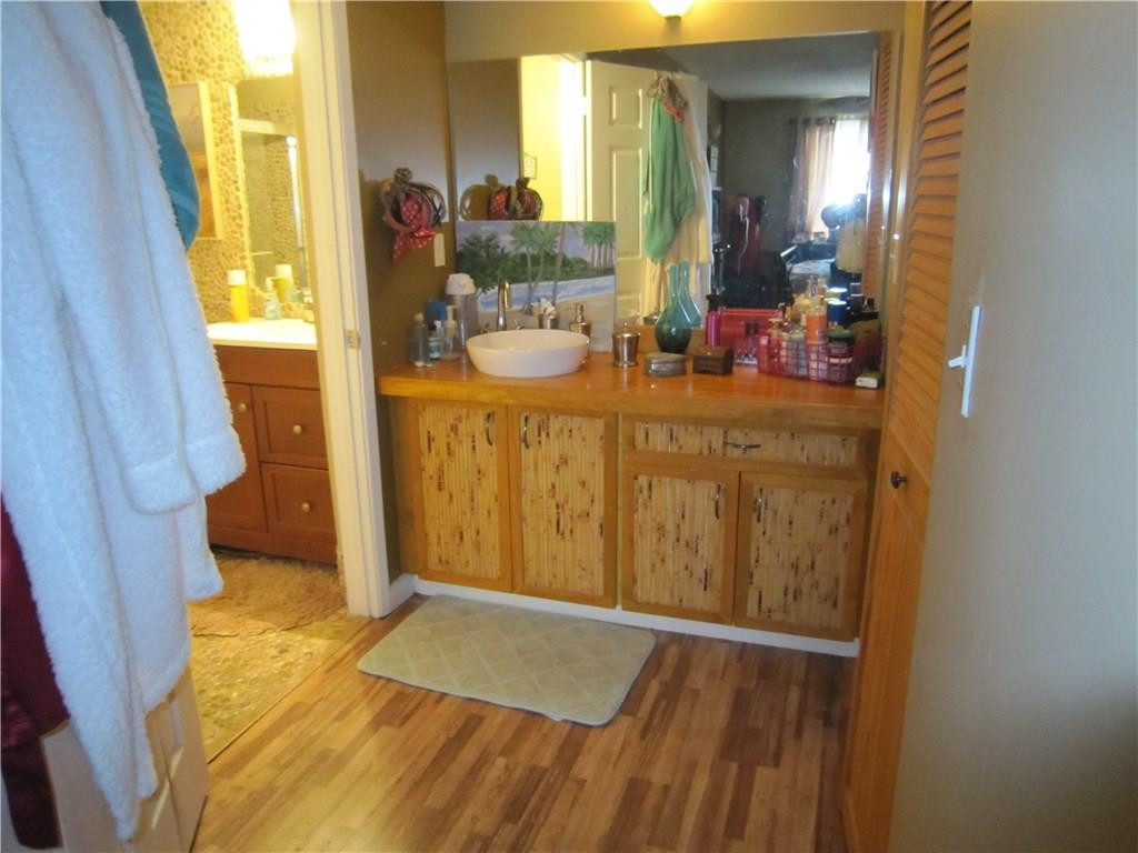 3874 Lyons Road, Unit 2036 Coconut Creek, FL 33073 - Photo 13 of 16 a bathroom with a sink mirror and a shower