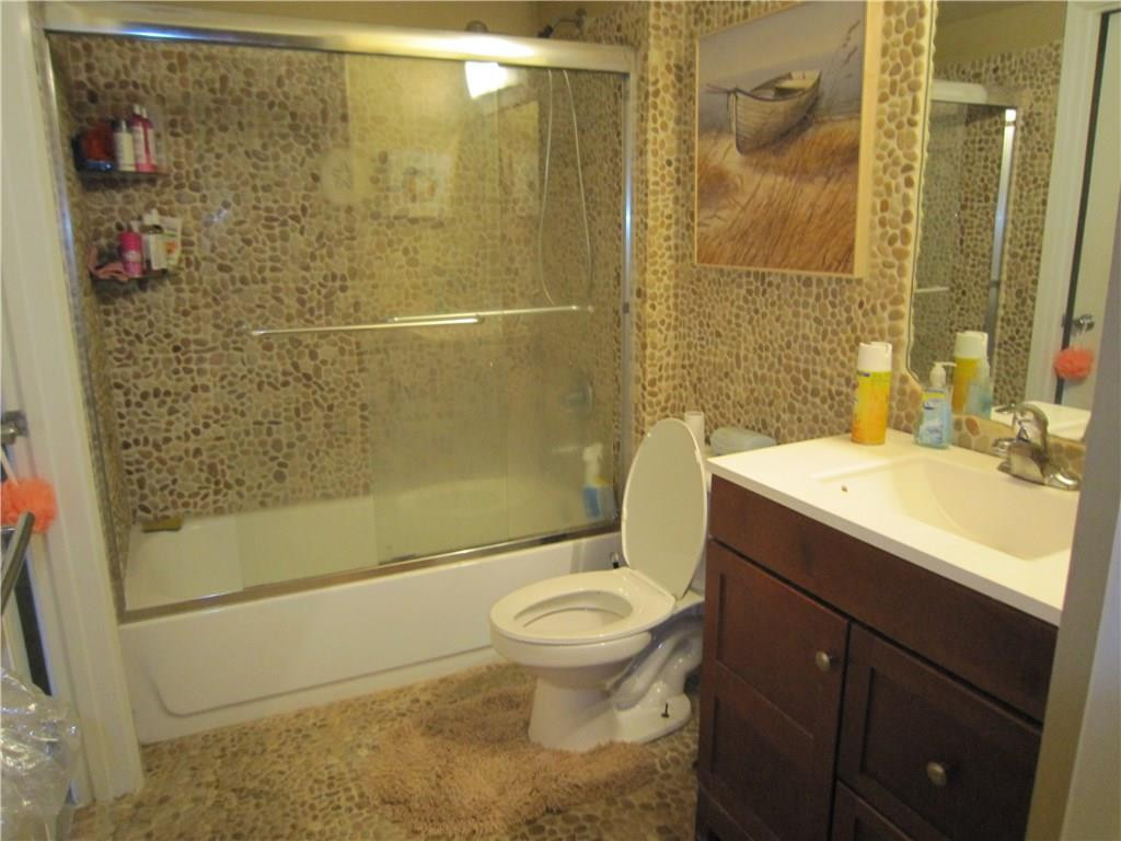 3874 Lyons Road, Unit 2036 Coconut Creek, FL 33073 - Photo 14 of 16 a bathroom with a sink toilet and shower