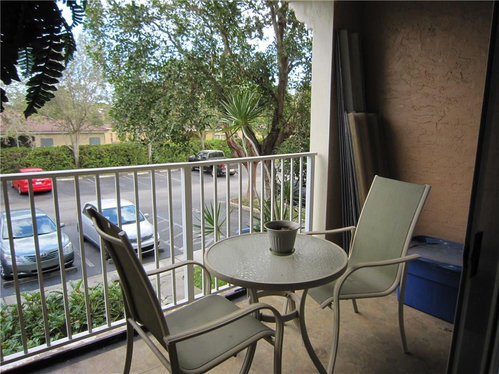 3874 Lyons Road, Unit 2036 Coconut Creek, FL 33073 - Photo 16 of 16 a balcony view with a seating space
