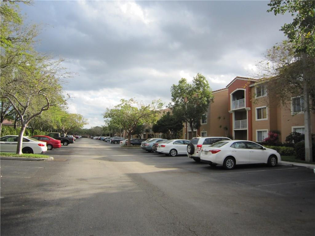 3874 Lyons Road, Unit 2036 Coconut Creek, FL 33073 - Photo 2 of 16 a view of street with parked cars