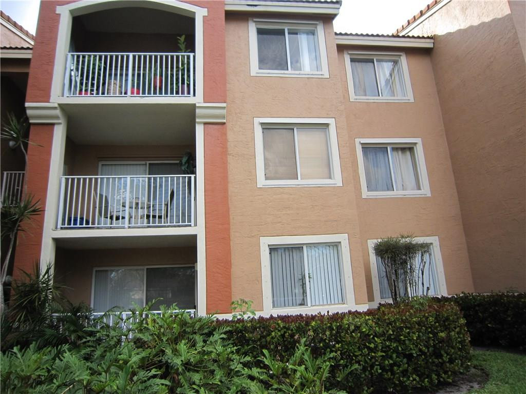 3874 Lyons Road, Unit 2036 Coconut Creek, FL 33073 - Photo 4 of 16 a view of a house with a porch