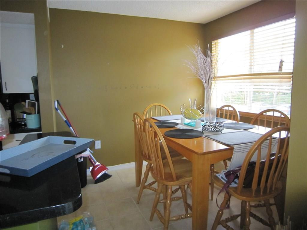3874 Lyons Road, Unit 2036 Coconut Creek, FL 33073 - Photo 8 of 16 a view of a dining room with furniture and window