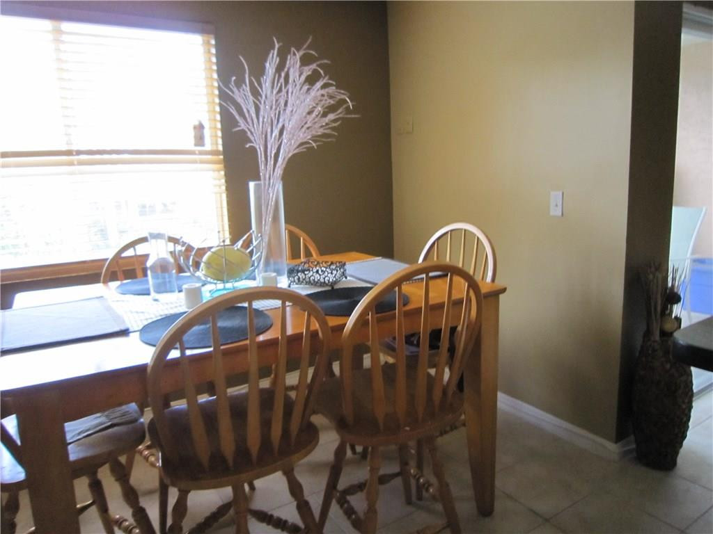 3874 Lyons Road, Unit 2036 Coconut Creek, FL 33073 - Photo 9 of 16 a view of a dining room with furniture and chandelier