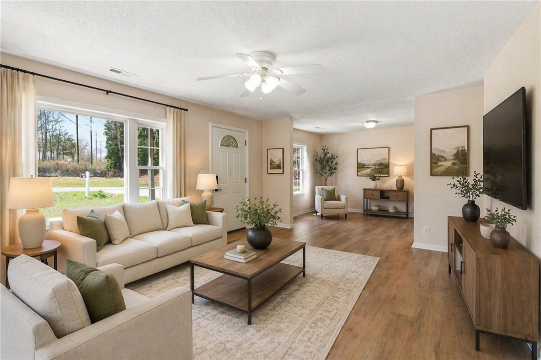 112 Newry Road Seneca, SC 29672 - Photo 2 of 19 This inviting living space features warm flooring and ample natural light, creating a comfortable atmosphere.
