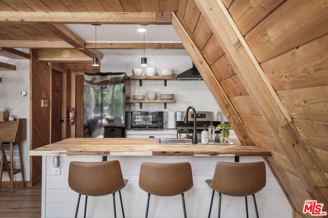 Undisclosed Address Big Bear City, CA 92314 - Photo 12 of 46 a kitchen with table and chairs