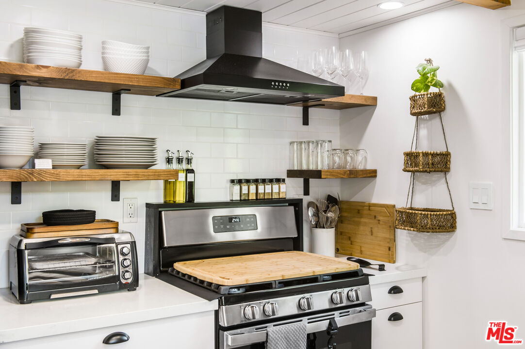 Undisclosed Address Big Bear City, CA 92314 - Photo 14 of 46 a kitchen with stainless steel appliances granite countertop a stove and a cabinets