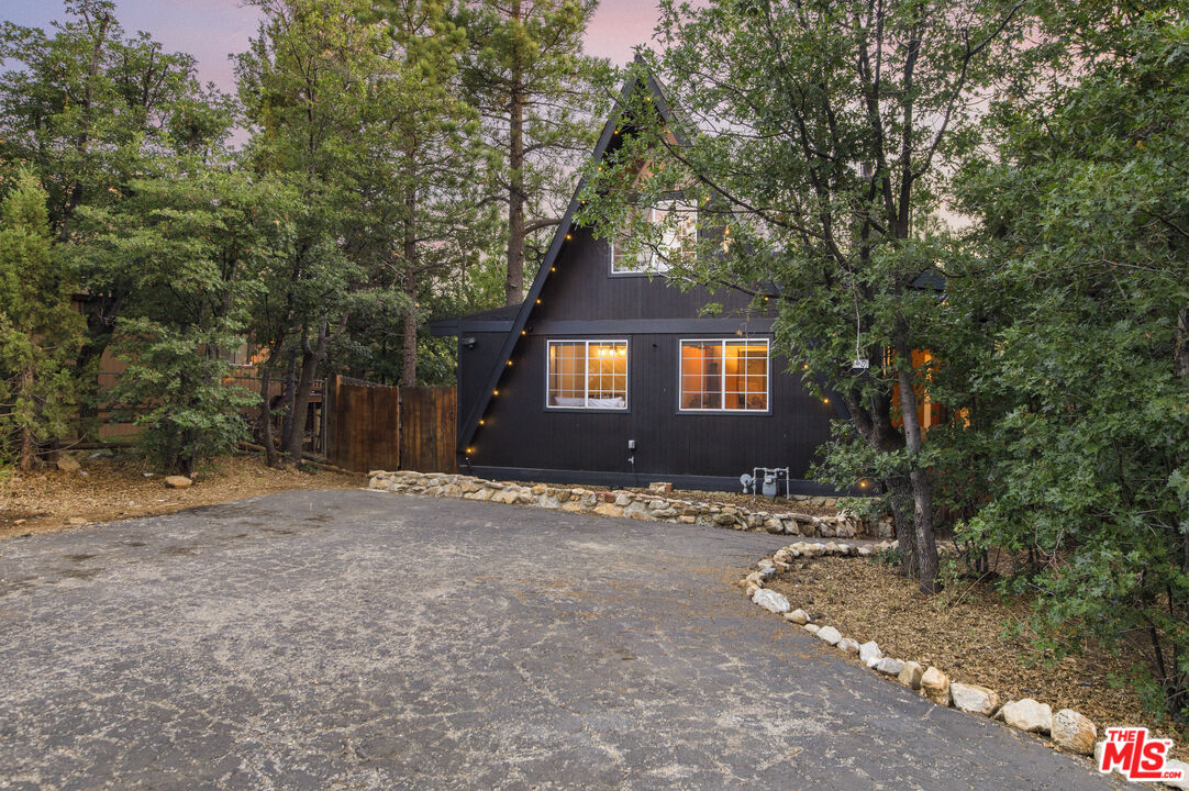 Undisclosed Address Big Bear City, CA 92314 - Photo 2 of 46 a front view of a house with a yard
