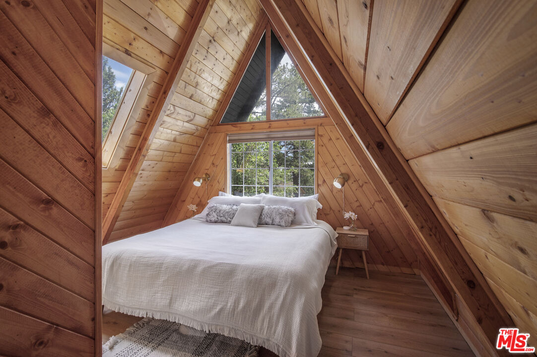 Undisclosed Address Big Bear City, CA 92314 - Photo 22 of 46 a bedroom with a bed and a large window