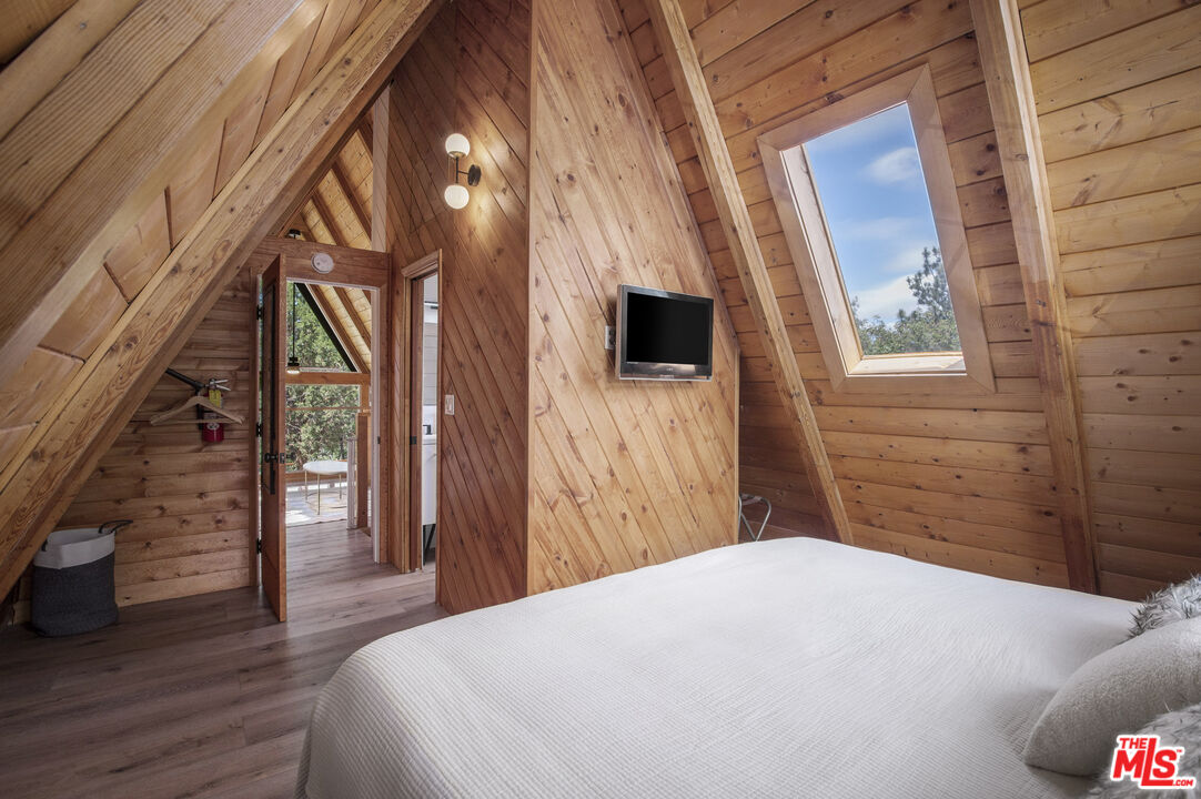 Undisclosed Address Big Bear City, CA 92314 - Photo 23 of 46 a bedroom with a bed and wooden floor