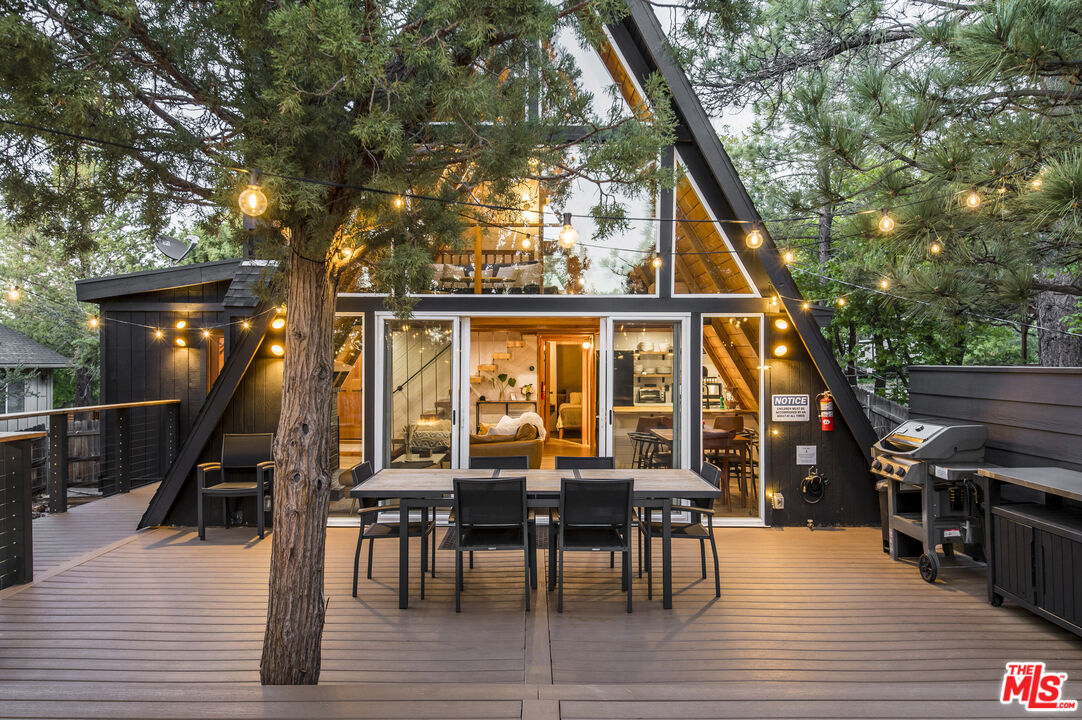 Undisclosed Address Big Bear City, CA 92314 - Photo 31 of 46 a view of a patio with dining table and chairs with wooden floor and fence