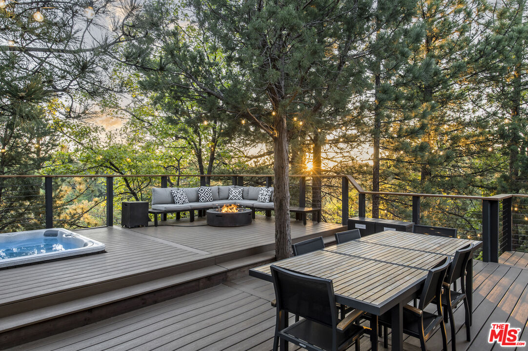 Undisclosed Address Big Bear City, CA 92314 - Photo 33 of 46 a roof deck with table and chairs and wooden floor