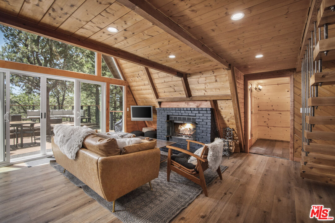 Undisclosed Address Big Bear City, CA 92314 - Photo 8 of 46 a living room with furniture and a fireplace