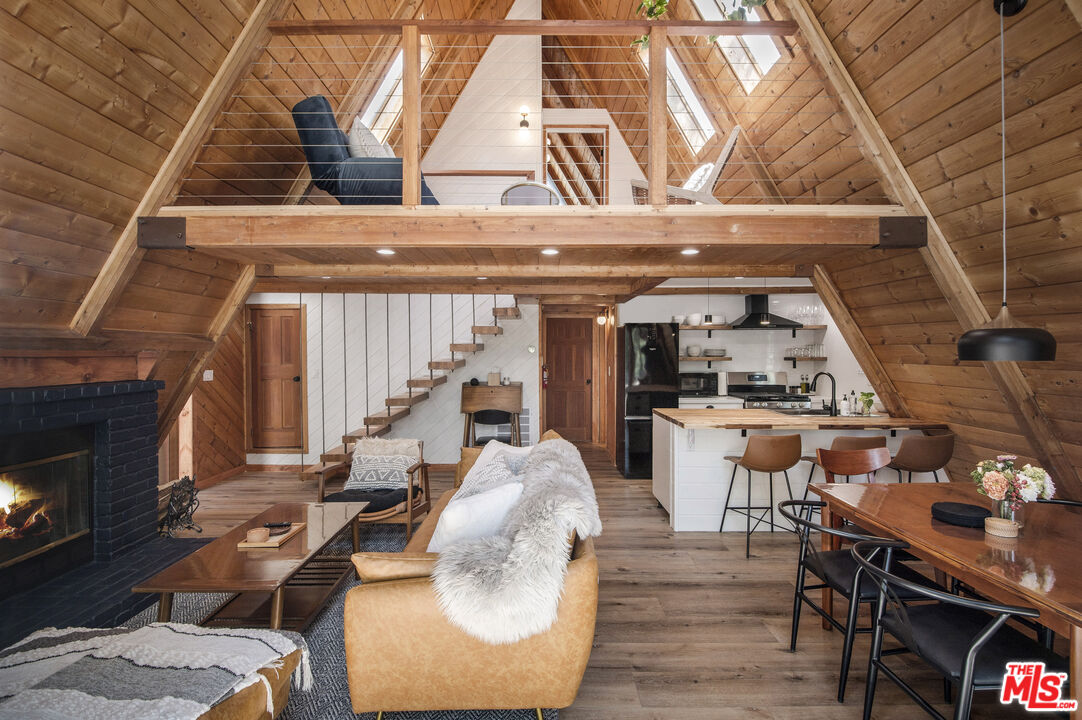 Undisclosed Address Big Bear City, CA 92314 - Photo 9 of 46 a living room with patio furniture and a fireplace