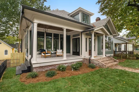 a living room filled with furniture and a chandelier