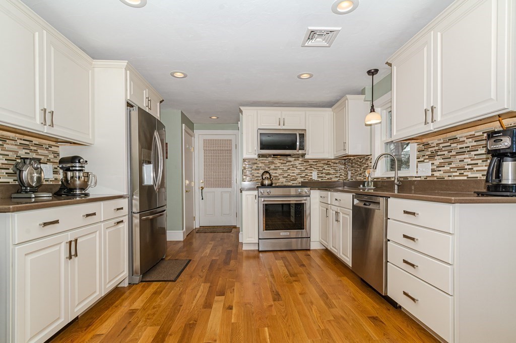 39 Chittick Road Boston, MA 02136 - Photo 7 of 24 a kitchen with granite countertop a sink cabinets stainless steel appliances and a counter space