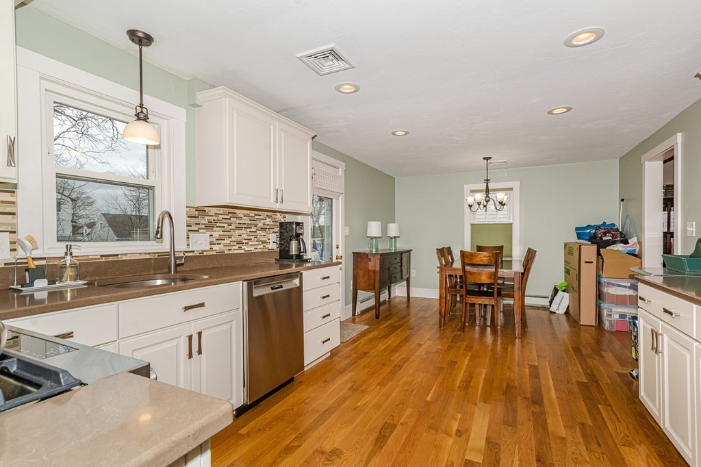 39 Chittick Road Boston, MA 02136 - Photo 8 of 24 a kitchen with granite countertop dining table chairs sink and cabinets