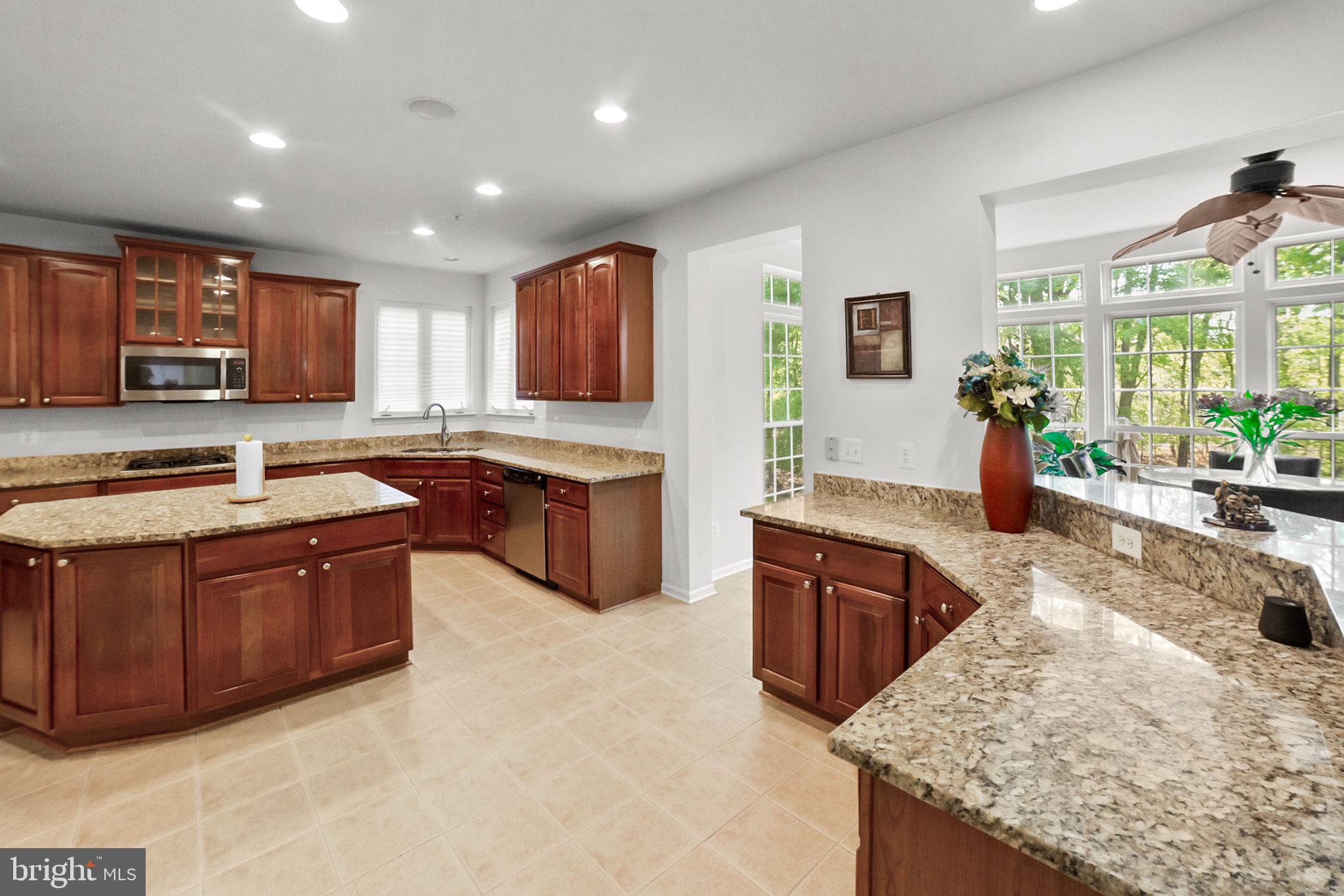 14909 Taryn Lea Court Accokeek, MD 20607 - Photo 18 of 49 a kitchen with stainless steel appliances granite countertop a sink stove and refrigerator