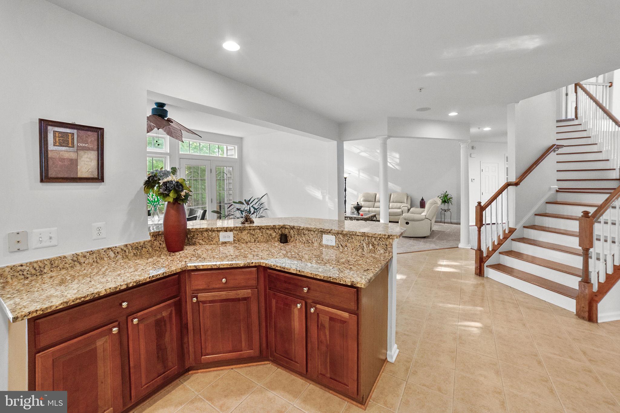14909 Taryn Lea Court Accokeek, MD 20607 - Photo 20 of 49 a kitchen with a sink and a wooden cabinets