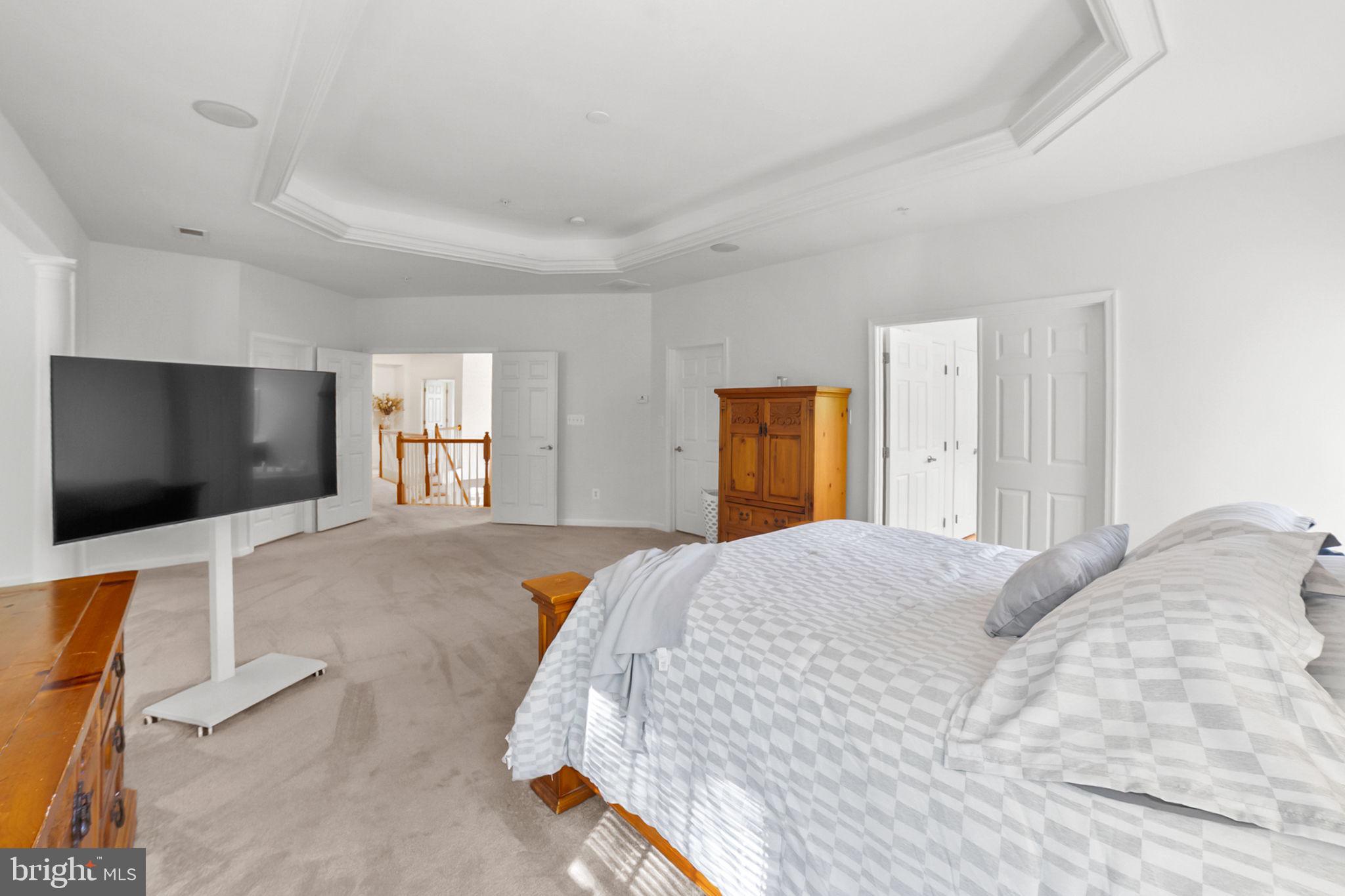 14909 Taryn Lea Court Accokeek, MD 20607 - Photo 40 of 49 a spacious bedroom with a bed and a flat screen tv