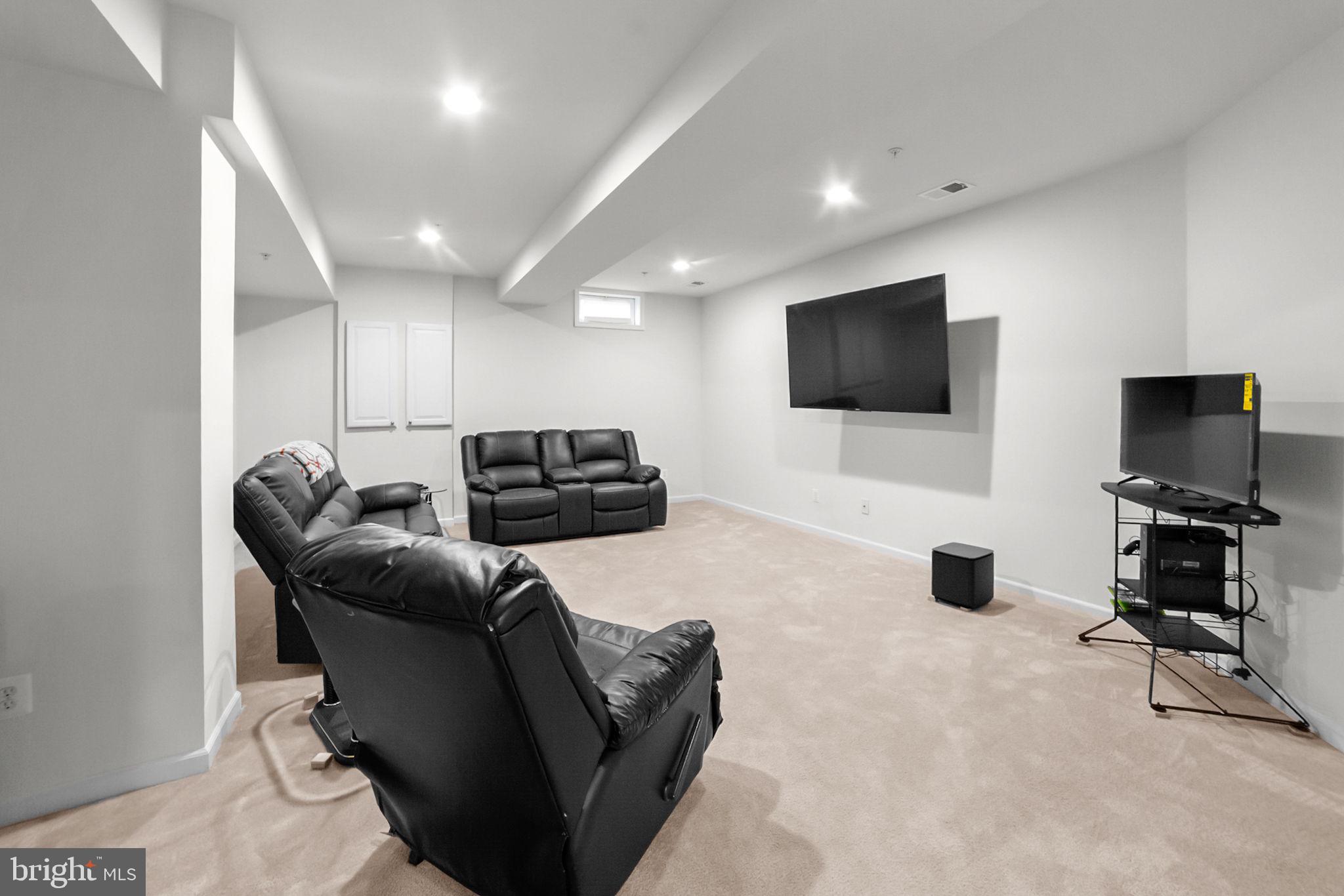 14909 Taryn Lea Court Accokeek, MD 20607 - Photo 44 of 49 a living room with furniture and a flat screen tv