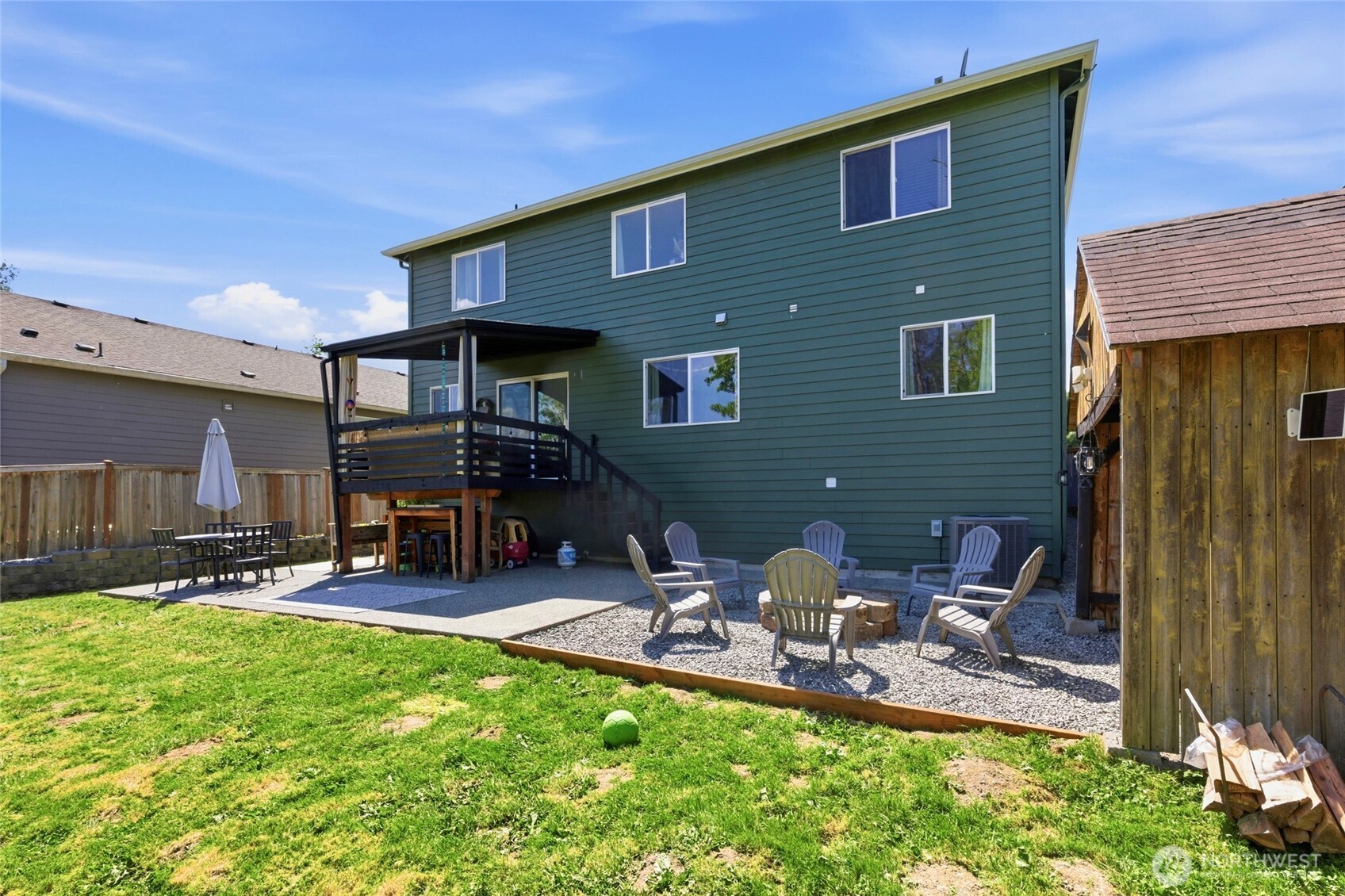 14005 Cedar Court Sultan, WA 98294 - Photo 32 of 38 a view of a backyard with table and chairs and a barbeque