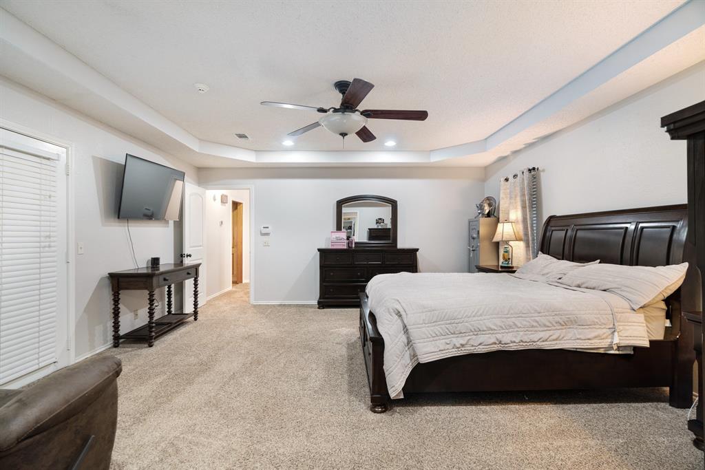 4145 Sleepy Hollow Reno, TX 75462 - Photo 12 of 20 a bedroom with a bed and a television