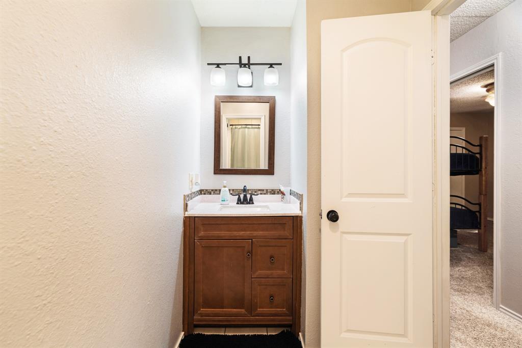 4145 Sleepy Hollow Reno, TX 75462 - Photo 17 of 20 a bathroom with a sink and a mirror