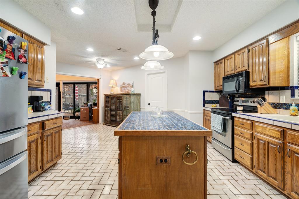 4145 Sleepy Hollow Reno, TX 75462 - Photo 5 of 20 a kitchen with stainless steel appliances granite countertop a sink stove and refrigerator