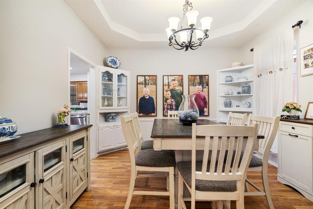 4145 Sleepy Hollow Reno, TX 75462 - Photo 7 of 20 a view of a dining room with furniture a chandelier and wooden floor