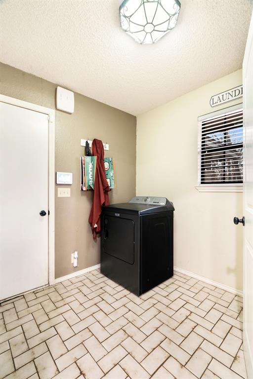 4145 Sleepy Hollow Reno, TX 75462 - Photo 10 of 20 a bedroom with a bed and a chandelier