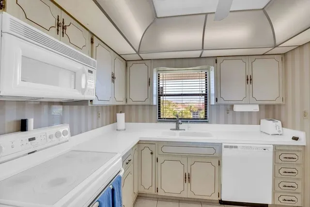 a kitchen with a sink cabinets and window